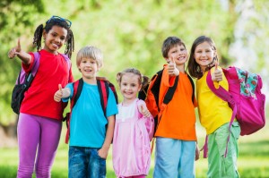 Group of school kids with their thumbs up.